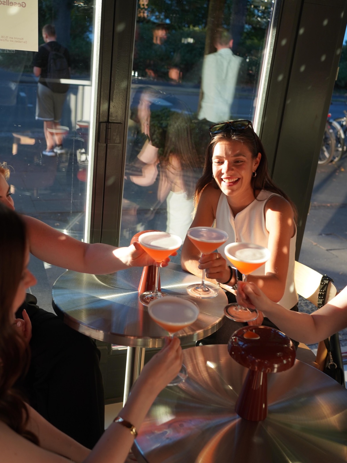 Freund:innen sto&szlig;en mit Cocktails an